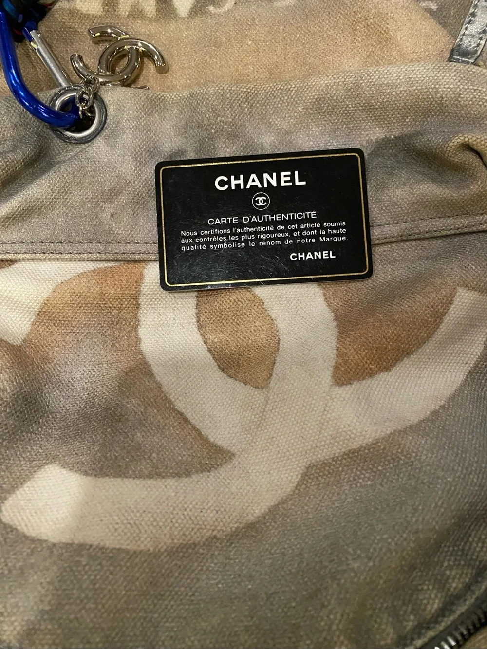 CHANEL Faded Beige Canvas Backpack with Multicolor Strap and Silver-Tone Charm